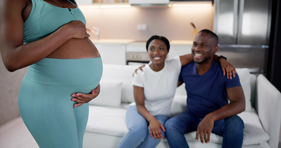 Surrogate Mother In Front Of Happy African Couple