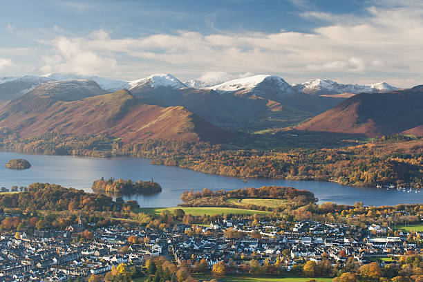 Keswick Classic view of Keswick, Derwent Water and the surrounding fells. Early cold spell led to a dusting of snow on the peaks while the last of the autumn colors covered the landscape around the lake. keswick stock pictures, royalty-free photos & images