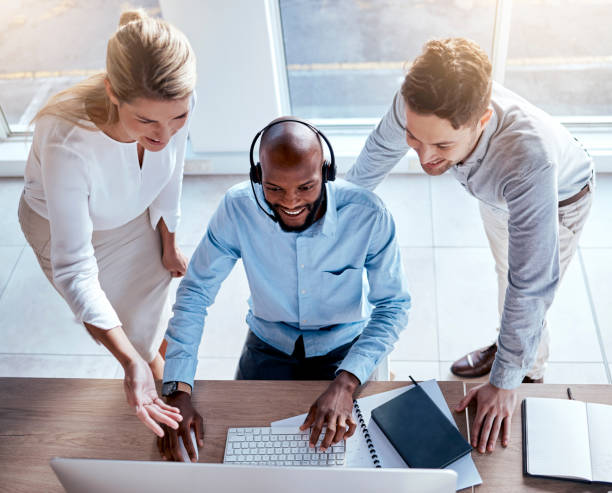 istock Call center employee training, help and business people in customer service with support and computer. Contact us, CRM and coworking top view with teaching and learning, coaching and collaboration 1572521496