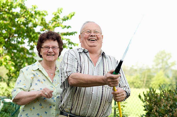 istock Senior couple watering the garden 157252507