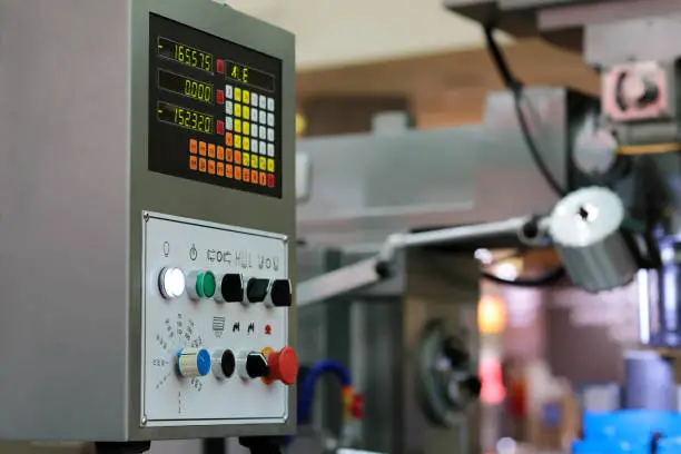 Control panel with digital readout of metalworking machine. Selective focus.