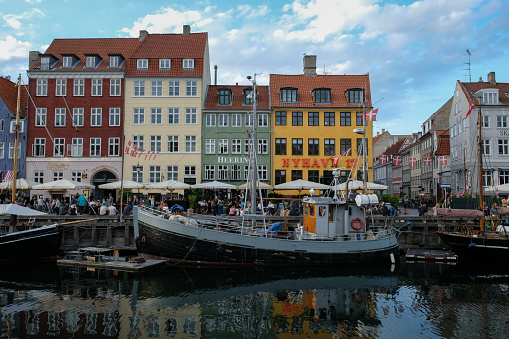 Svaneke, Denmark - August 14, 2015: Tourists enjoy the sunny weather and walking along the quay at the port.