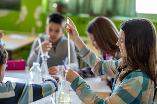 istock teenagers at school experiment in science class 1572539009