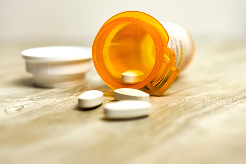 Amoxicillin/Clavulanic Acid 500 mg tablets with orange prescription bottle