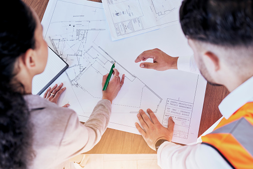 Architecture, planning and blueprint with top view of people for project management, drawing and engineering. Floor plan, documents and teamwork with group of contractors for designer or construction