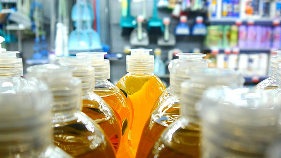 Close-up of many bottles of detergent  or dishwashing liquid on a store shelf