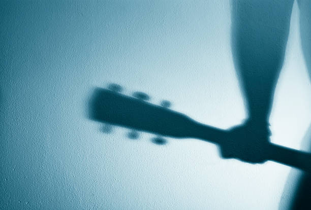 istock Guitarist Shadow On The Wall 157256570
