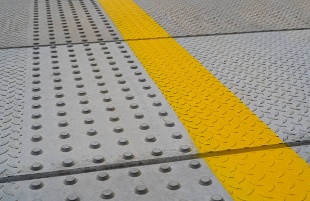 istock Tactile Paving on Modern Tiles Pathway for Blind Handicap, Safety Sidewalk Walkway for Disability People 1572568972