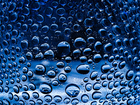 Water droplets on a black background. Beautiful drops of water in black and white. Lots of small drops of water on black.