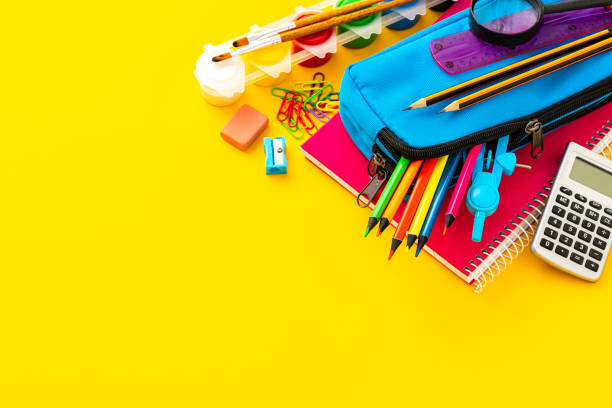 istock Colored school supplies shot on yellow background. Copy space 1572580167