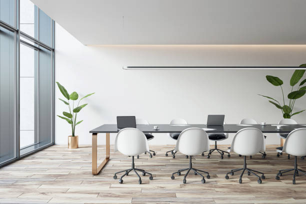 istock Side view of empty modern conference room with office table and chairs, panoramic window, wooden floor and white walls. 3D Rendering 1572583836
