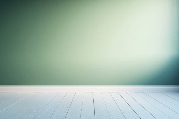 istock Front view on blank sunlit green wall background with space for advertising poster or product presentation in empty room with light wooden floor. 3D rendering, mockup 1572585391