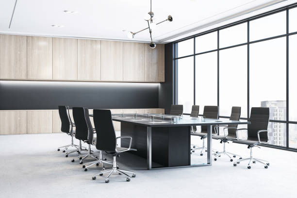 istock Perspective view of modern empty meeting room interior with office table and chairs, window, concrete floor and wooden walls. 3D Rendering 1572587006