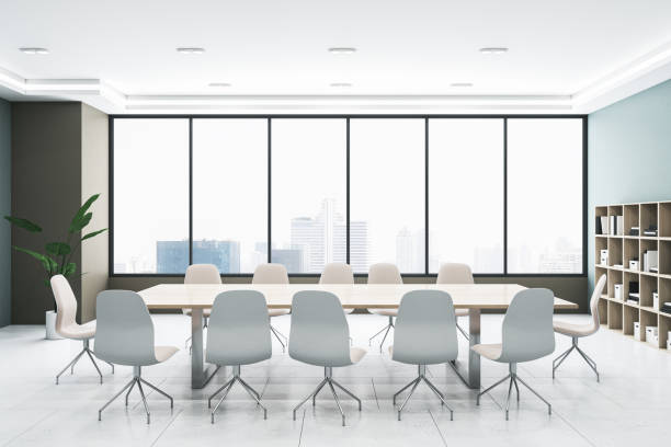 istock Front view of light modern meeting room with panoramic city view window on background, grey floor and large office desk. 3D Rendering 1572587550