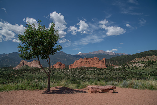 Massive red sandstone rock formations at entry to the Garden of the Gods in Colorado Springs, Colorado in western USA of North America. Pikes Peak in the background.