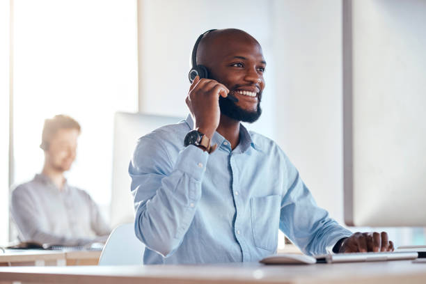 istock Call center, computer and listening with black man in office for customer service, technical support and advice. Technology, contact us and communication with employee operator in help desk agency 1572595085