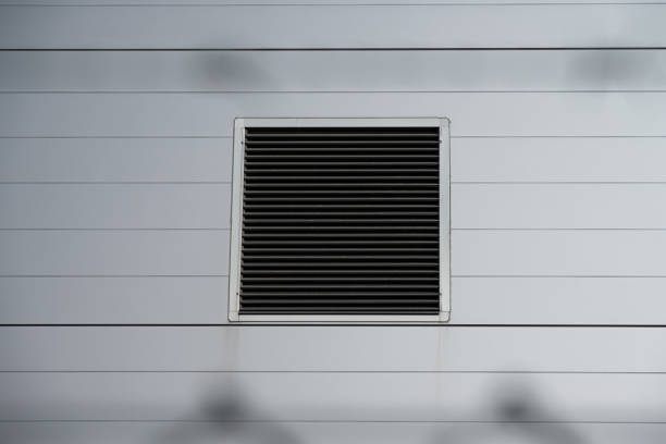 istock Vent in the wall of a large warehouse. 1572605828
