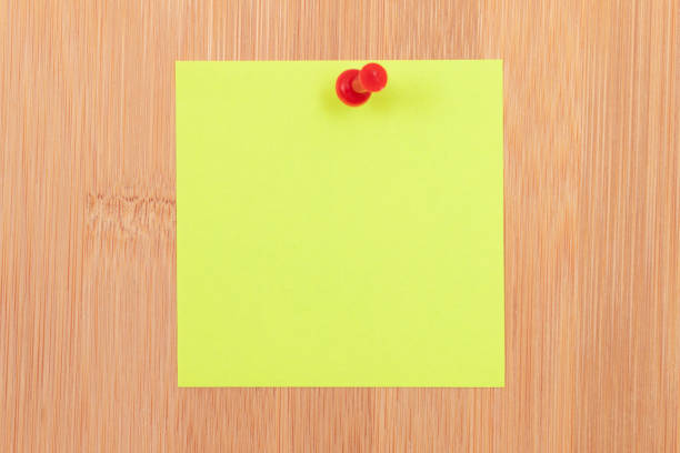 istock Yellow Sticky Note Pinned to the Wooden Message Board 1572606408