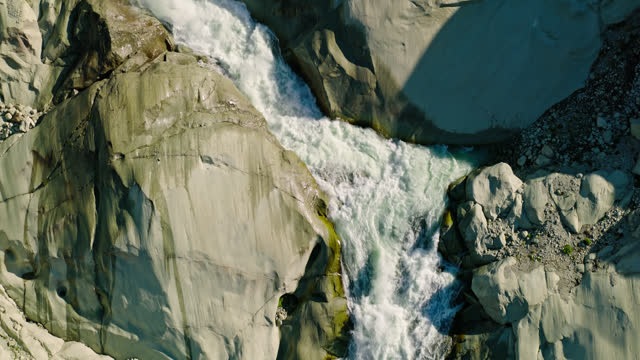 Ascending Aerial Shot of Waterfall at the Source of the Rhône River - Slow Motion