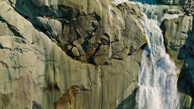 Ascending Drone Shot of Waterfall at the Source of the Rhône River - Slow Motion