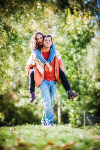 istock Falling in love. Romantic couple enjoying in meadow walk together 1572644496