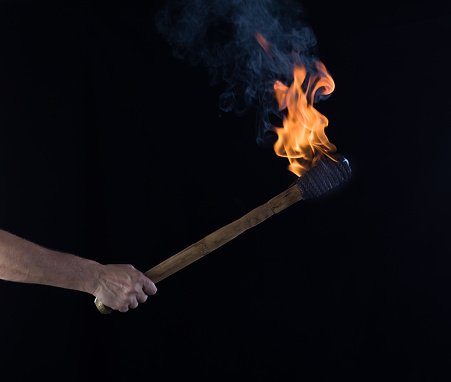 wooden match is burning on black background