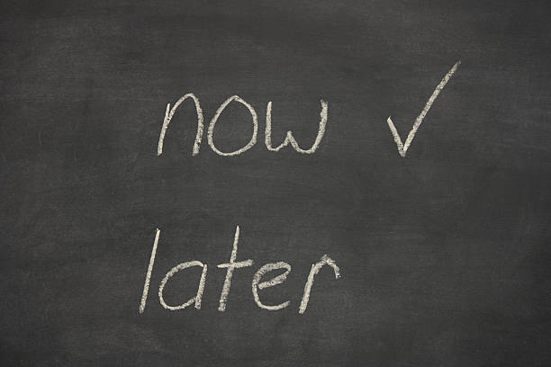istock now later written on a chalk board / blackboard 157268293