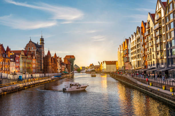 Canal in Gdansk Motorboat on canal in Gdansk at sunset, Poland gdansk city stock pictures, royalty-free photos & images