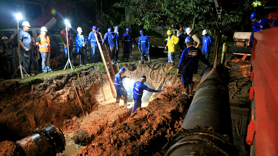 salvador, bahia, brazil - june 18, 2023: Embasa workers repair pipes in the drinking water distribution network in Salvador.