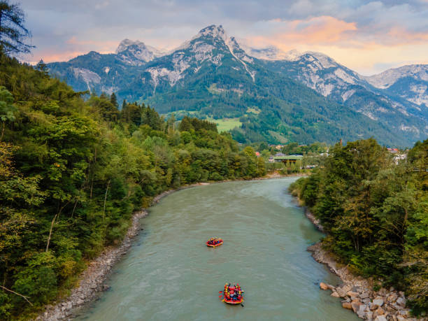 adventurous river rafting in the austrian alps join the thrilling journey on the rapids with boats and brave souls - rafting on a mountain river imagens e fotografias de stock