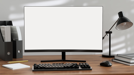 A modern, dark office at night with a white-screen computer mockup and office supplies on the desk. 3d render, 3d illustration