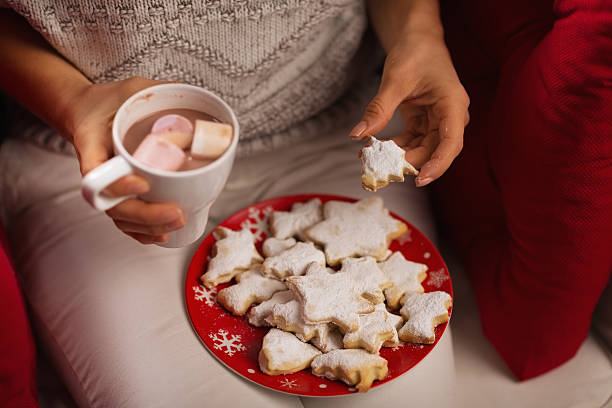 istock Closeup on woman eating cookie and drinking chocolate with marshmallows 157271415
