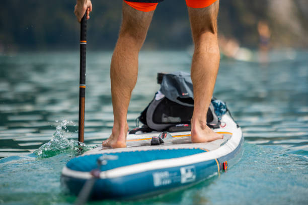 istock Man Paddling with an Inflatable SUP Stand-Up Paddle Board 1572717152