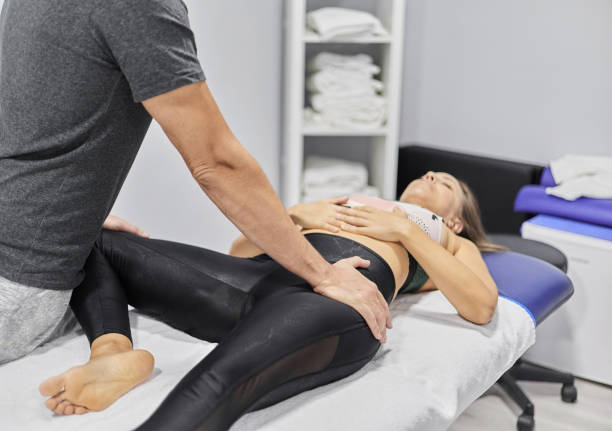 istock Crop masseuse treating female client 1572721394