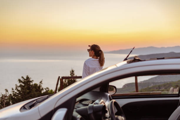 istock Woman enjoys the glorious summer scenery on her journey 1572740342