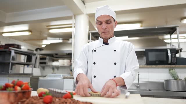 Head chef preparing a sweet pie in a commercial kitchen