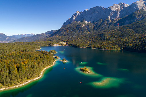 Aerial view of a mountain landscape with a turquoise lake in Bavarian Alps, Germany.