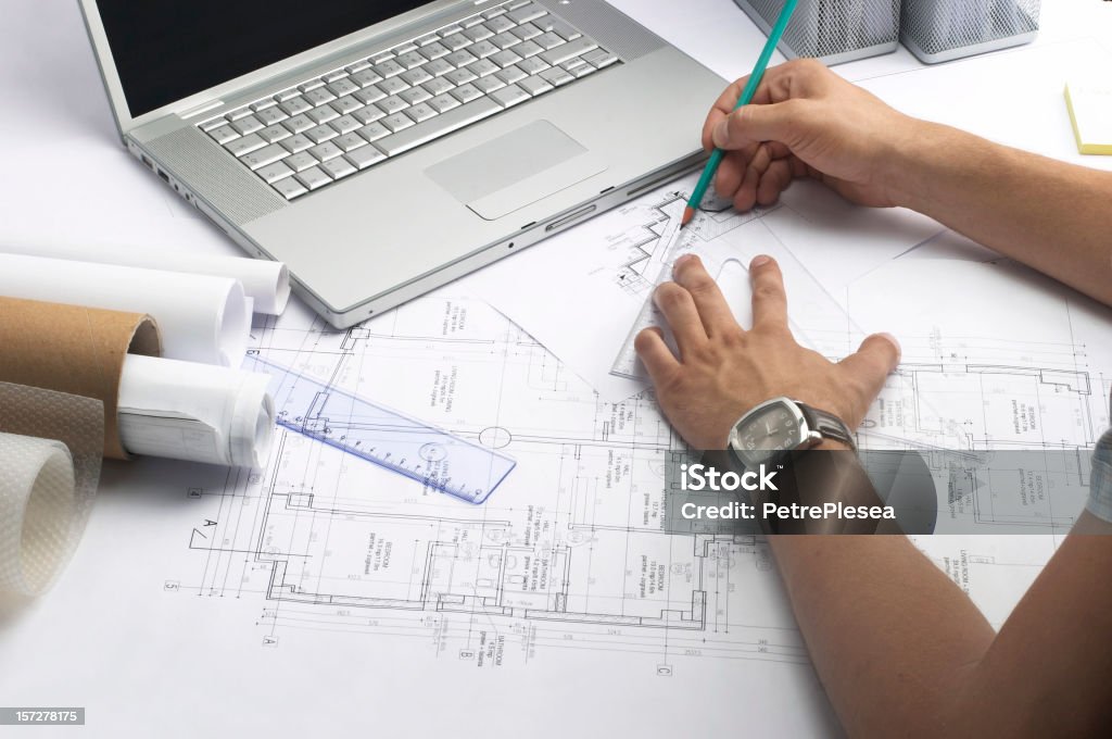 Person working on measurements for a drawing of a building Architect working Blueprint Stock Photo