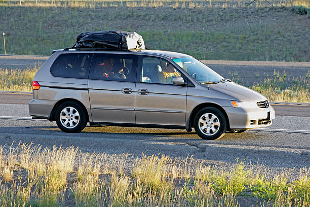 Family vacation in a gray minivan stock photo