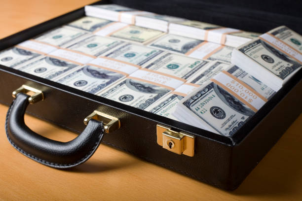 istock Attache full of money on the table 157278348