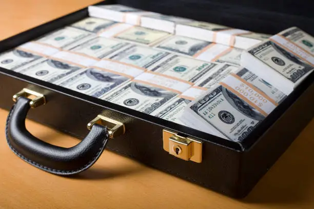 Photo of Attache full of money on the table