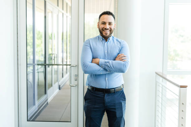 Mid adult male financial banker smiles for the camera stock photo