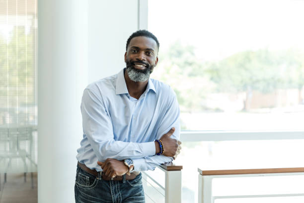 istock Mature male CEO poses for the camera 1572784002