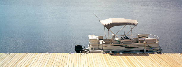 Mielno, Poland - May 12, 2025: There are boats that are moored at the pier of a small marina. This marina is on Jamno Lake.