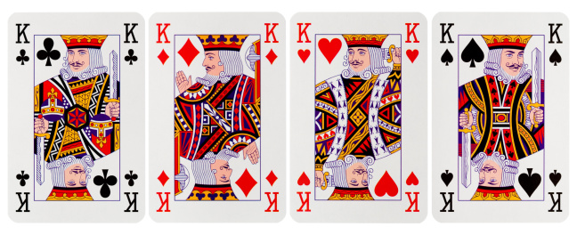 Deck of playing cards standing on black background and ace is on top of the deck.
