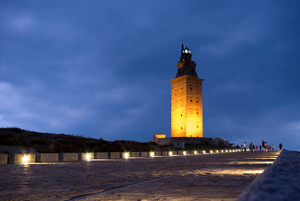 Landscape of Hercules Tower illuminated at dusk Hercules Tower at night in A Coru&#241;a, a lighthouse in the north of Spain a coruna province stock pictures, royalty-free photos & images