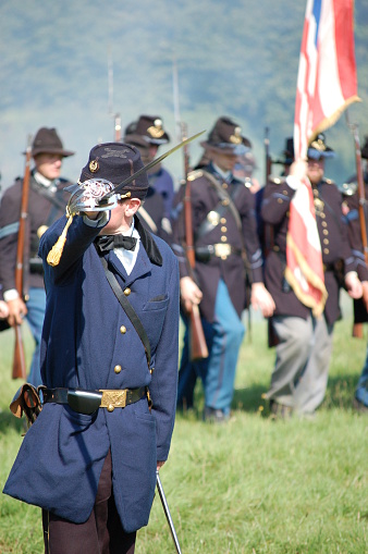 Civil war Officer commands his troops froward on the balltefield.Re-enactors of the American civil war at the Military Odyysey show 07.
