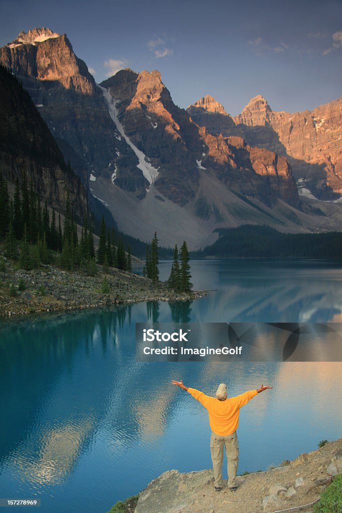 Middle Aged Caucasian Man Lifts His Hands in Mountains A man lifts his arms in the mountains. Valley of the Ten Peaks, Alberta, Canada. Middle aged Caucasian male lifting his hands in a pristine mountain setting. Canadian rockies are in the background and this is Morraine Lake, one of the most stunning mountain lakes in the world. Additional themes include praise and worship, joy, peace, gratitude, salvation, hope, happiness, contentment, and beauty in nature.  Freedom Stock Photo