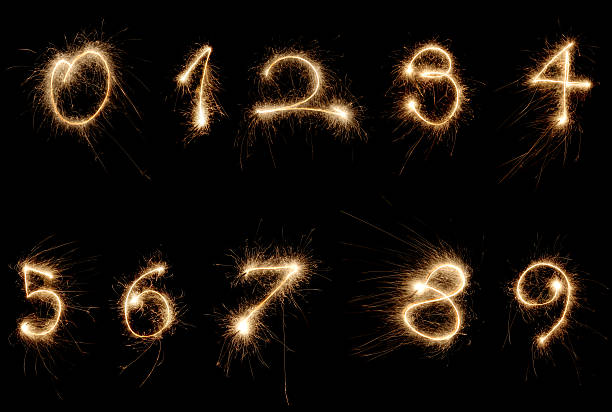 sparkler numbers 0-9 written with sparklers in the black sky. 9 stock pictures, royalty-free photos & images