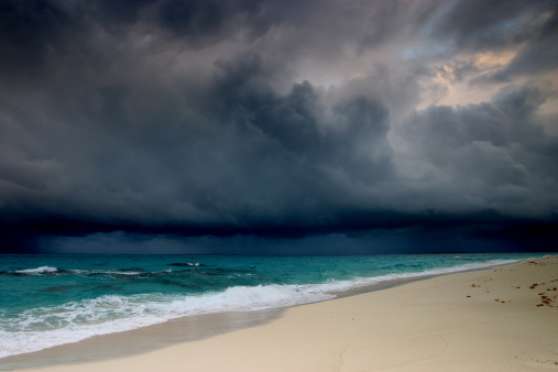 Stormy sea under dark stormy sky with fata morgana on the horizon. Large panoramic seascape at sunset